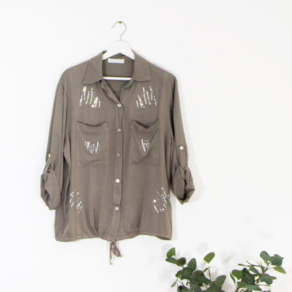 Dressy shirt with random sequin elements and drawstring hem