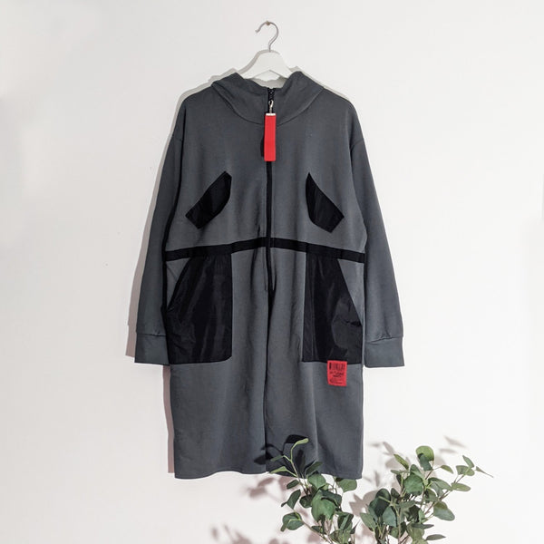 Long length hooded top with parka fabric elements and red zip pull